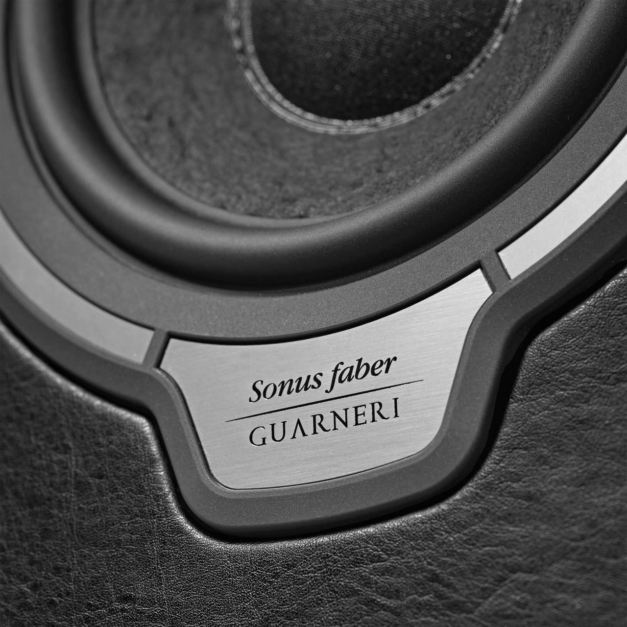 Close-up of Sonus faber Guarneri G5 bookshelf speaker, featuring the Sonus faber logo and luxurious Italian leather finishes.