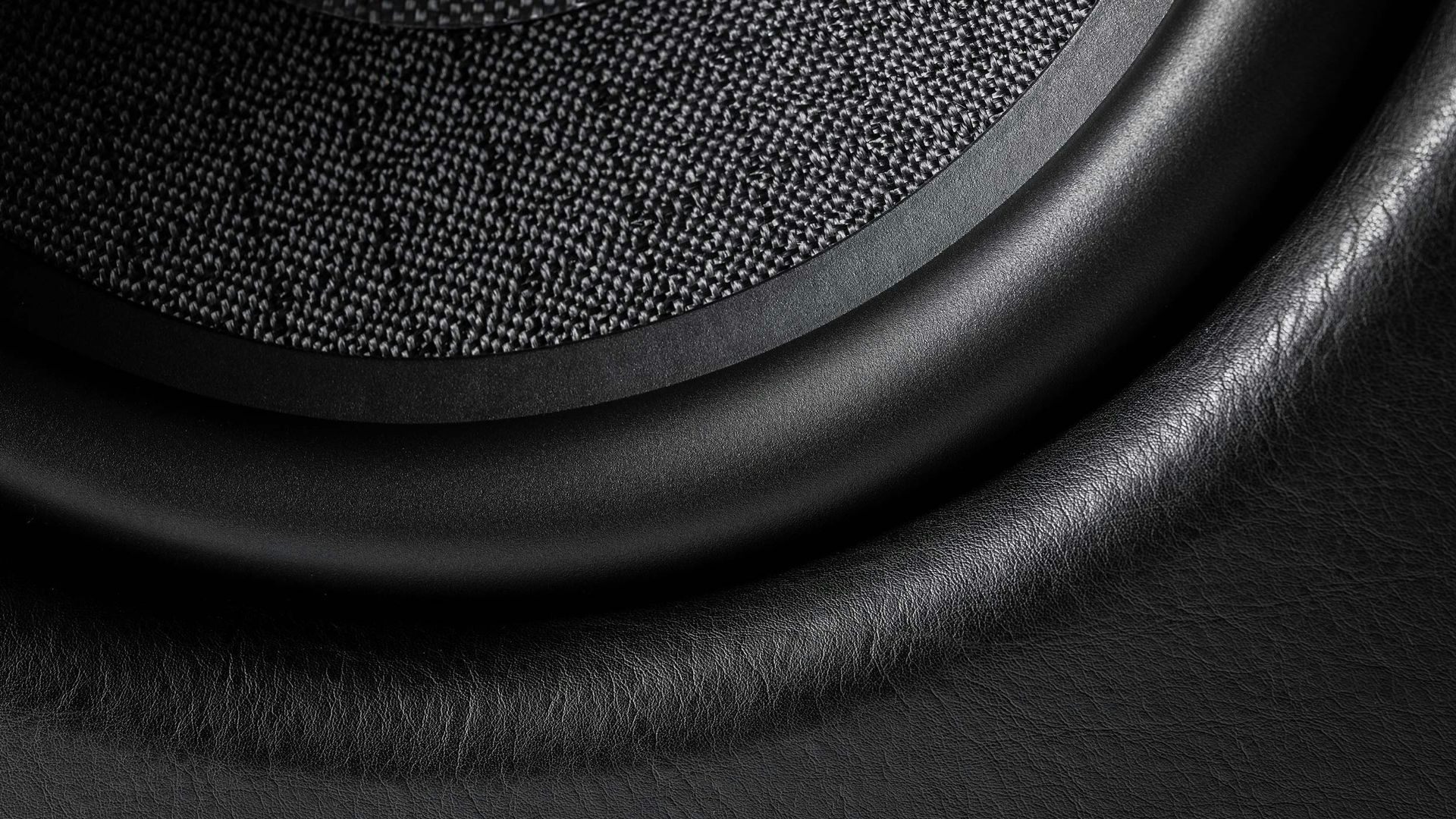 Close-up of the intricate black leather details on a Sonus faber Gravis III subwoofer, showcasing the craftsmanship.