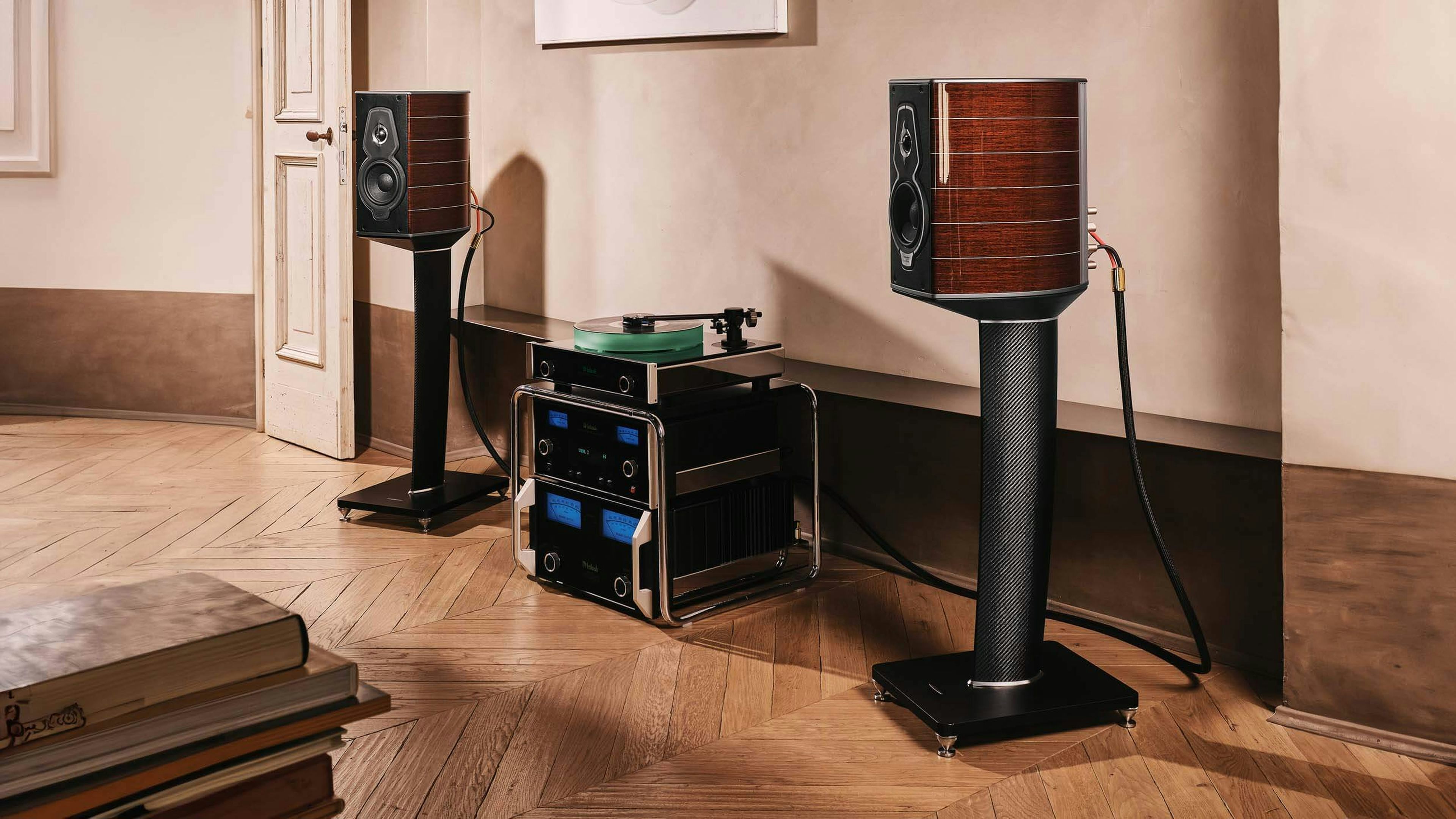 Pair of Sonus faber Guarneri G5 bookshelf speakers with stands in a home audio room, complemented by McIntosh speakers.