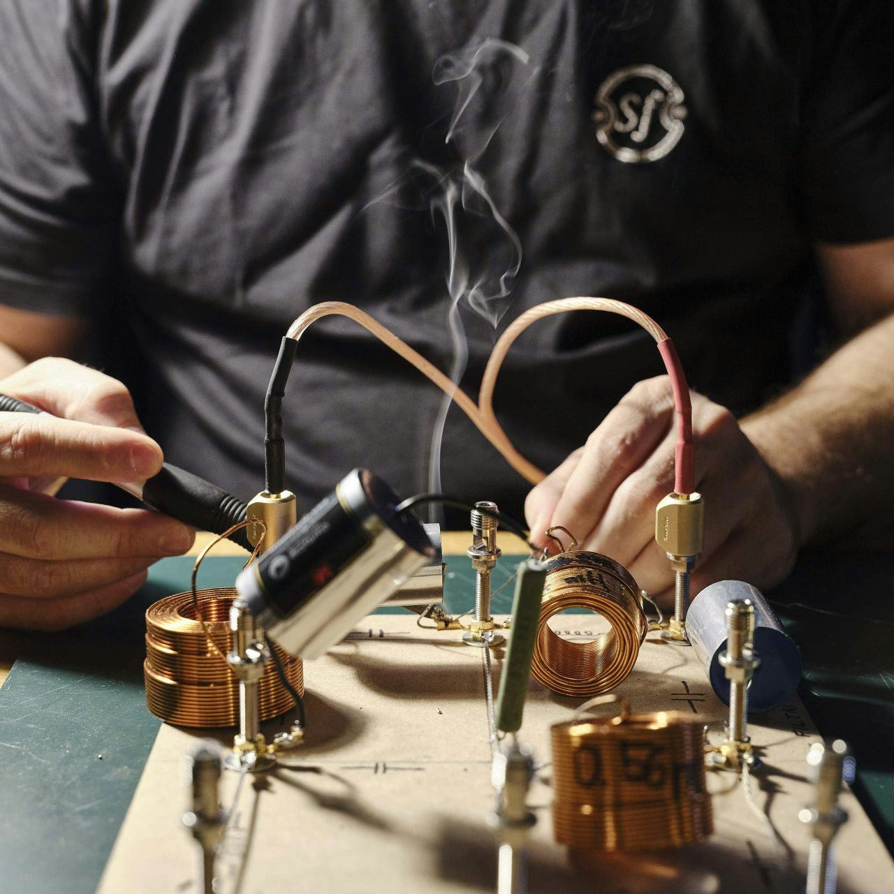 Sonus faber artisan hand-soldering the Maxima Amator's crossover for an incredibly natural and fluid sound.