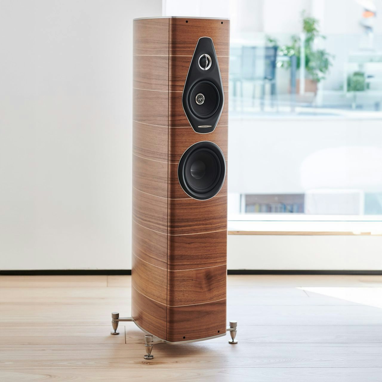 A Sonus faber Olympica Nova II floorstanding speaker in Walnut Wood, Italian leather finishes, gracing a warm home audio room.