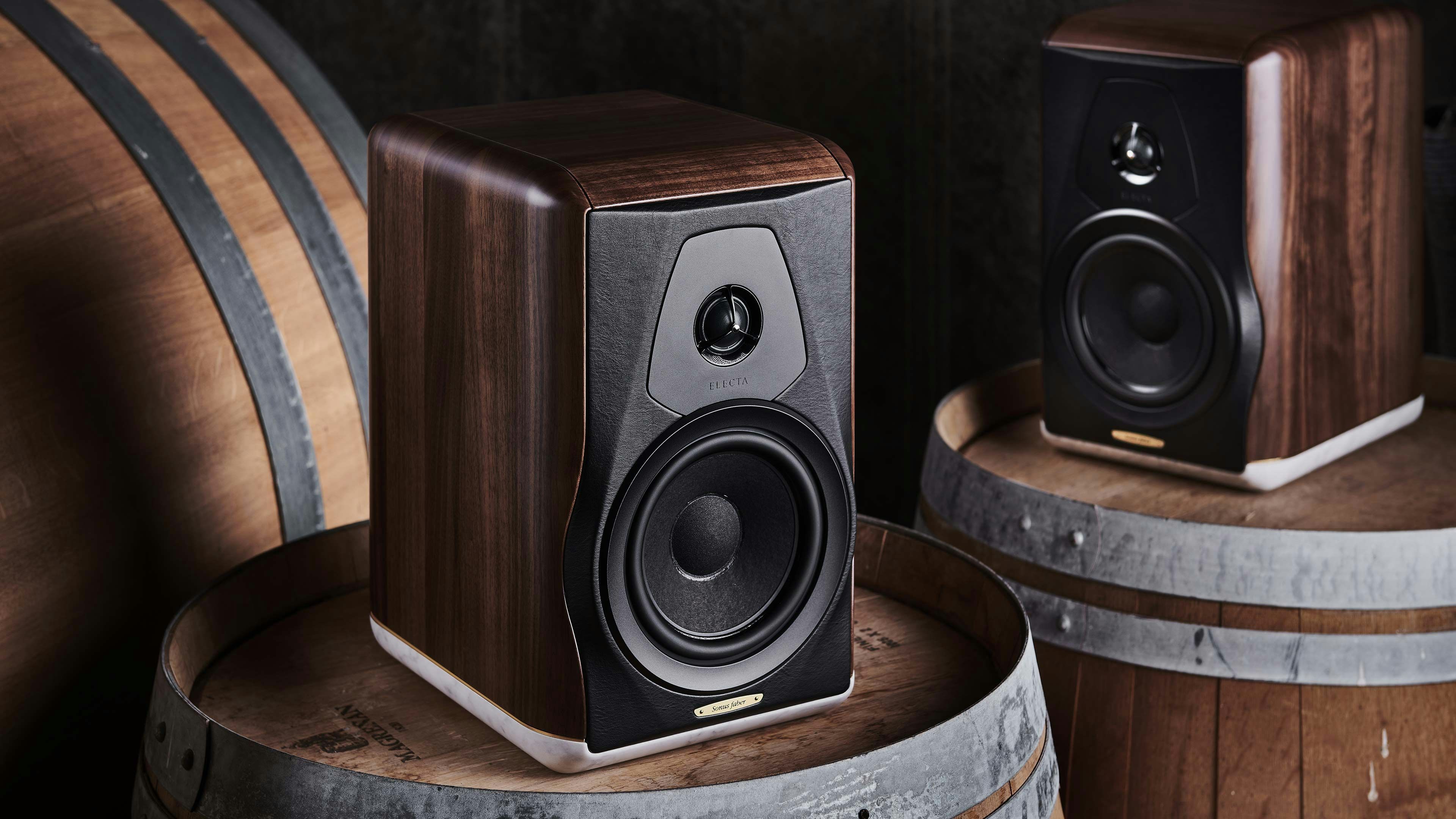 Electa Amator III speaker by Sonus faber in Solid Walnut finish, elegantly positioned on a wooden barrel for a captivating aesthetic.