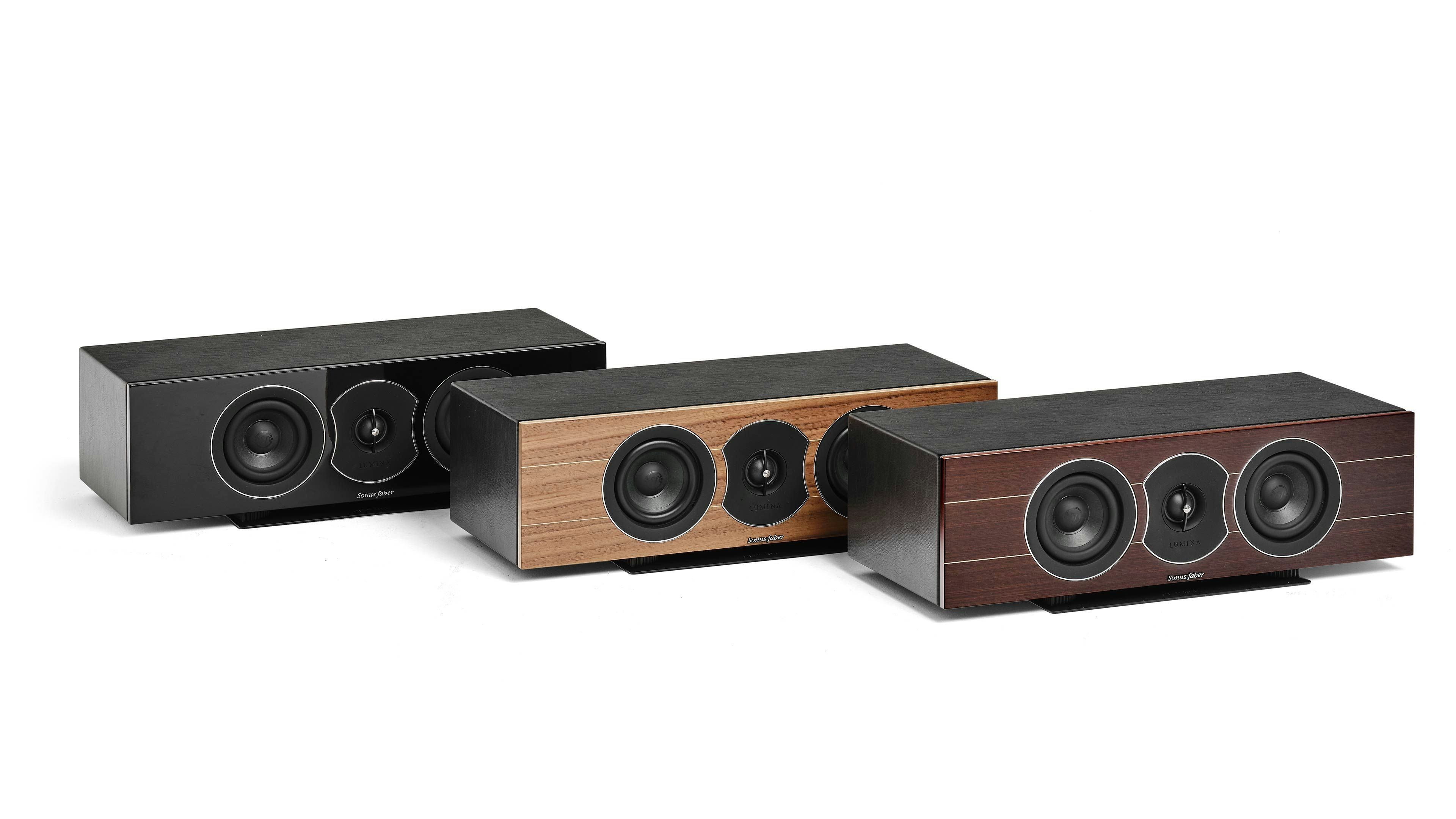 A trio of Sonus faber Lumina CI center channel speakers showcasing diverse finishes: piano black, walnut, and wenge wood.