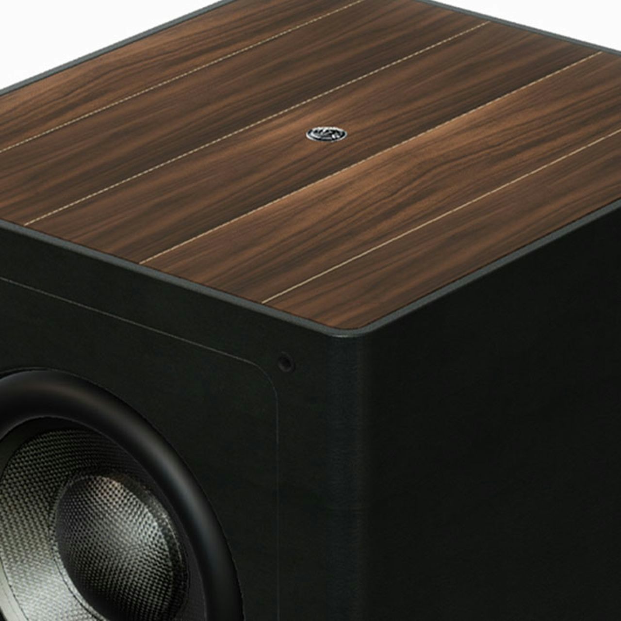 A close-up of the walnut wood top and black leather details on a Sonus faber Gravis III subwoofer, showcasing the natural materials.