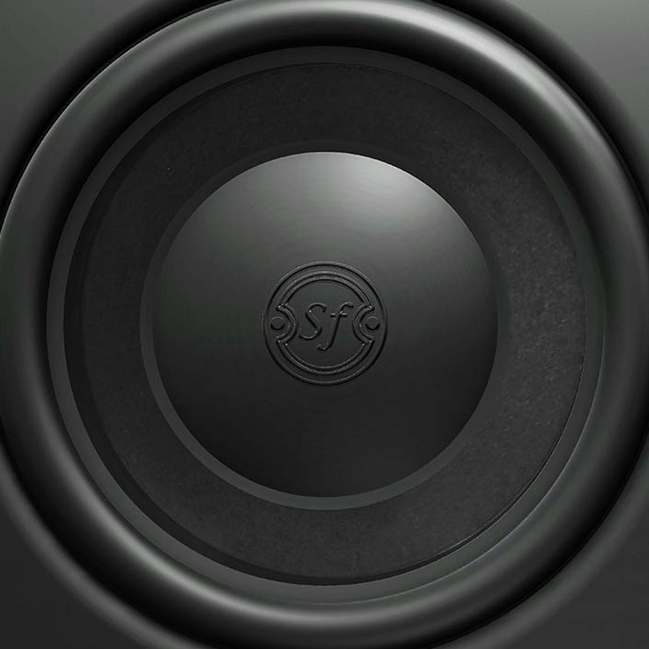 Close-up of the Sonus faber PS-G101 in-wall passive subwoofer, highlighting the 'Sf' logo and intricate details.