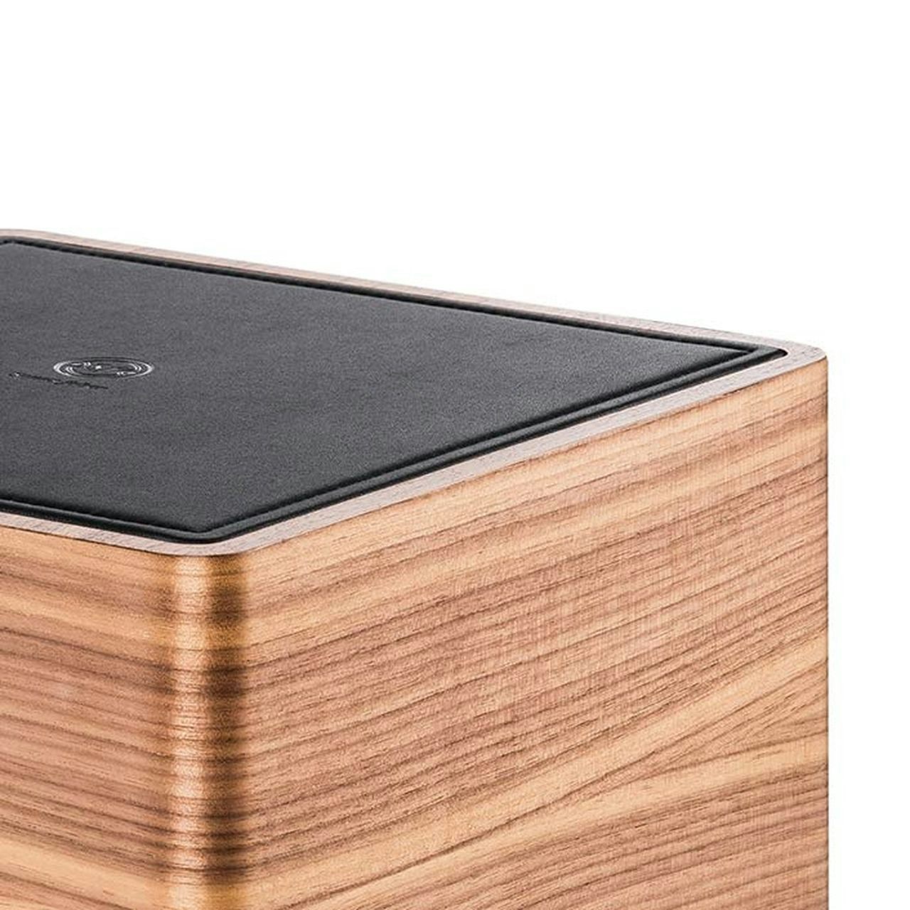 Close-up of the Sonus faber Gravis I subwoofer, highlighting the exquisite walnut wood and black leather finishes.